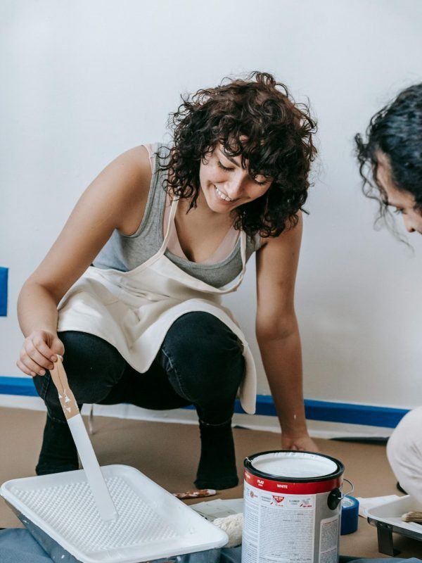 Interior painting supplies in use — roller, tray, and paint bucket for home renovation